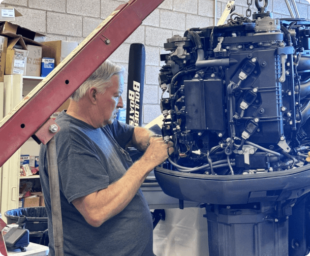 A man working on an engine in a shop.