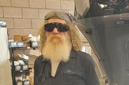 A man with long white beard and sunglasses.