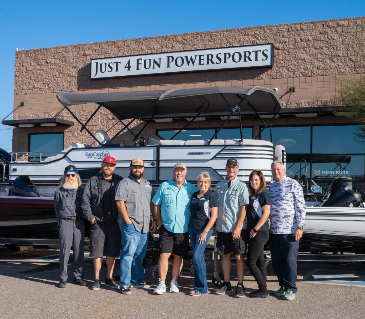 A group of people standing in front of a boat.